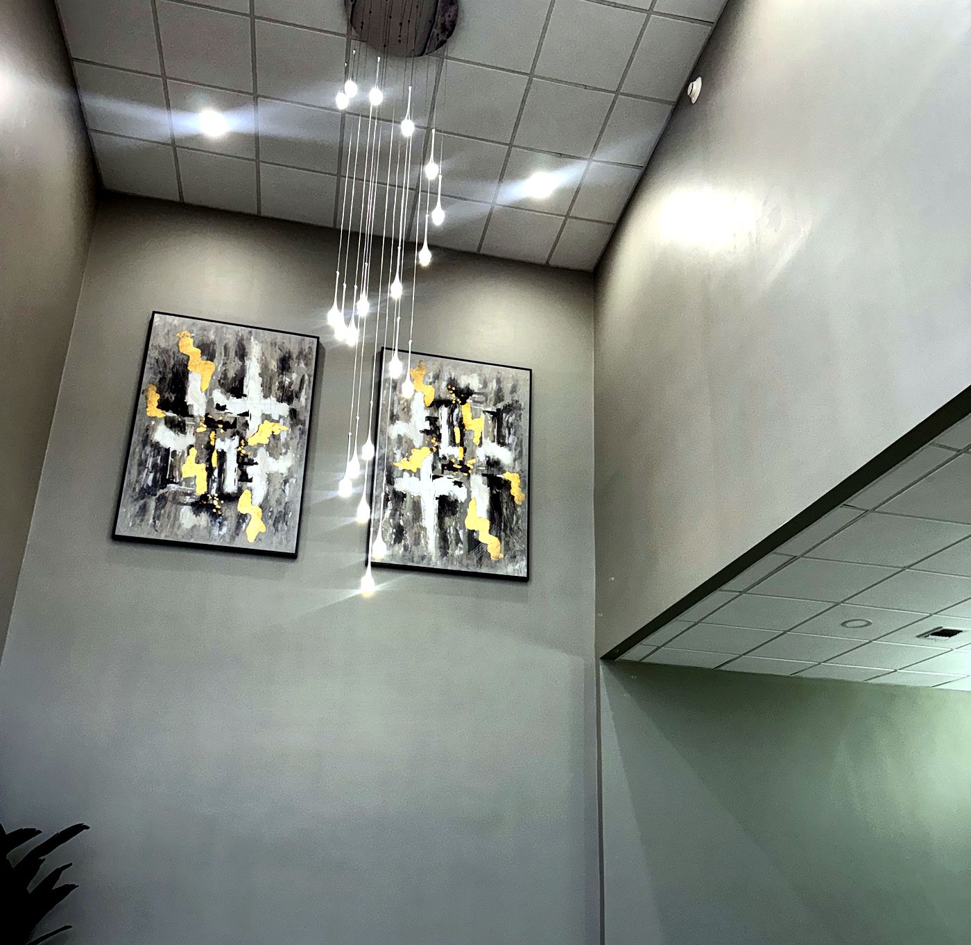 Foyer with artwork and cascading pendant lights